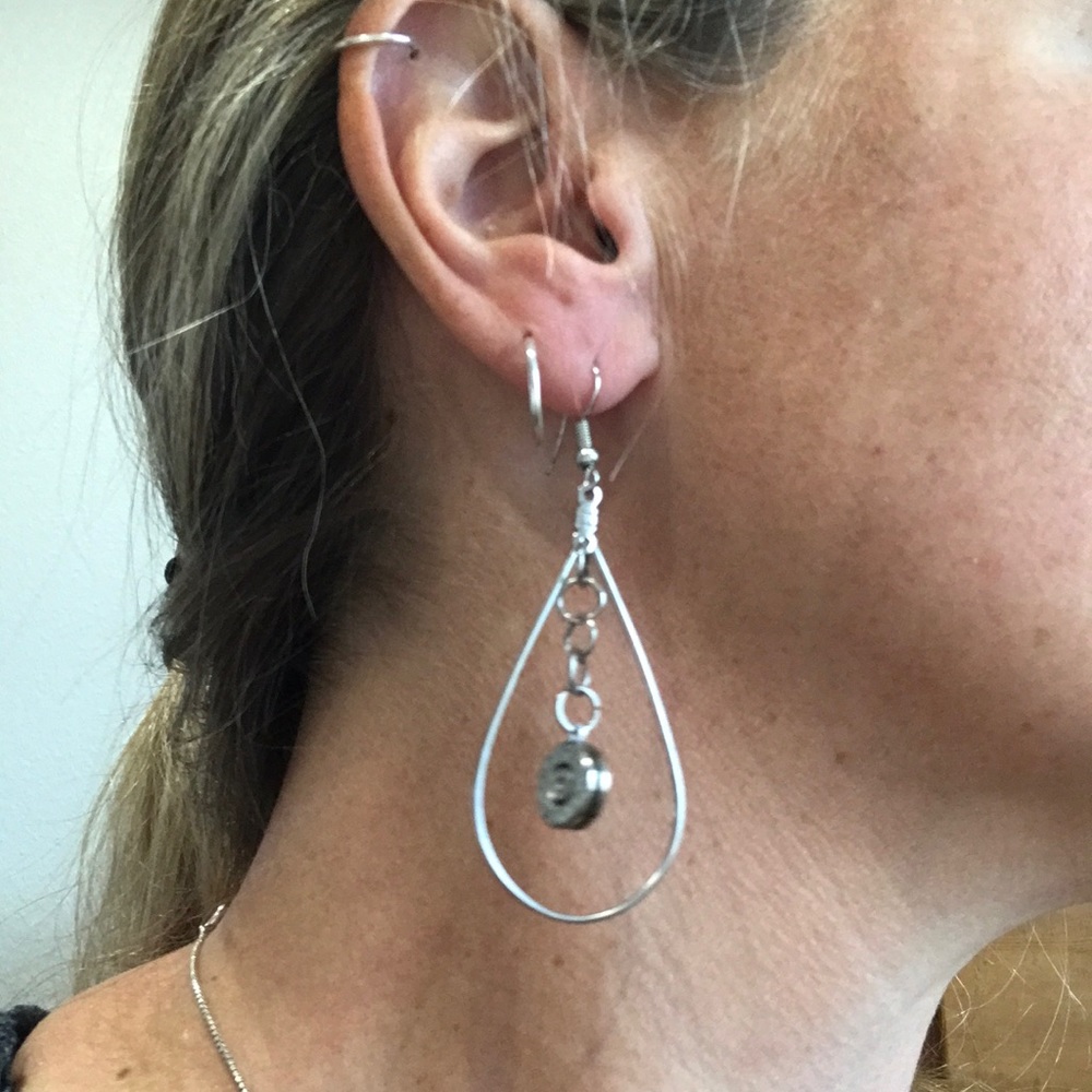 Earrings, the center dangle spins and is part of a gun shell